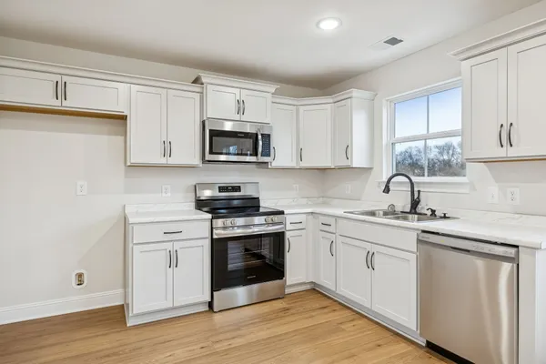 a kitchen with appliances cabinets and a sink
