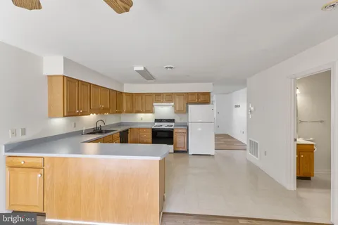 a large white kitchen with cabinets
