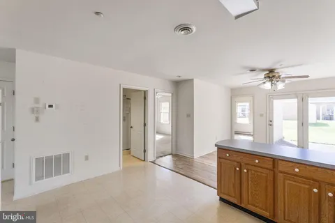 a spacious bathroom with a granite countertop sink a mirror and a shower