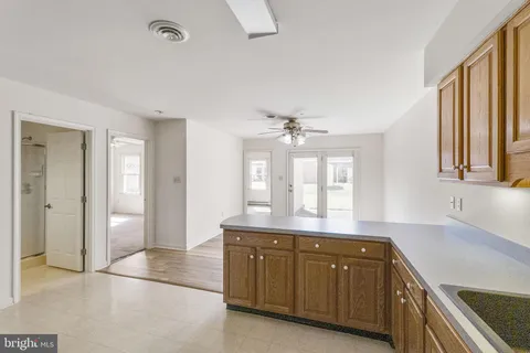 a spacious bathroom with a granite countertop sink mirror and a bathtub