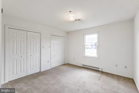 an empty room with a empty space and windows