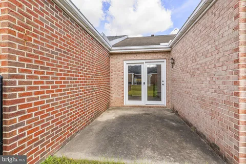 a view of a brick house with a large window