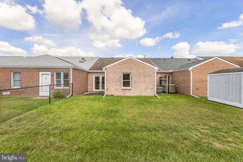 a view of a yard in front of a house with a garden