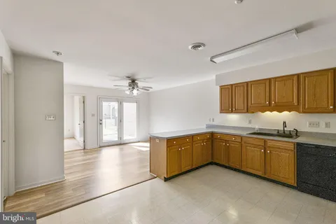 a kitchen with granite countertop a sink and cabinets
