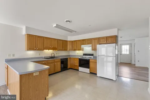 a kitchen with a refrigerator and a sink