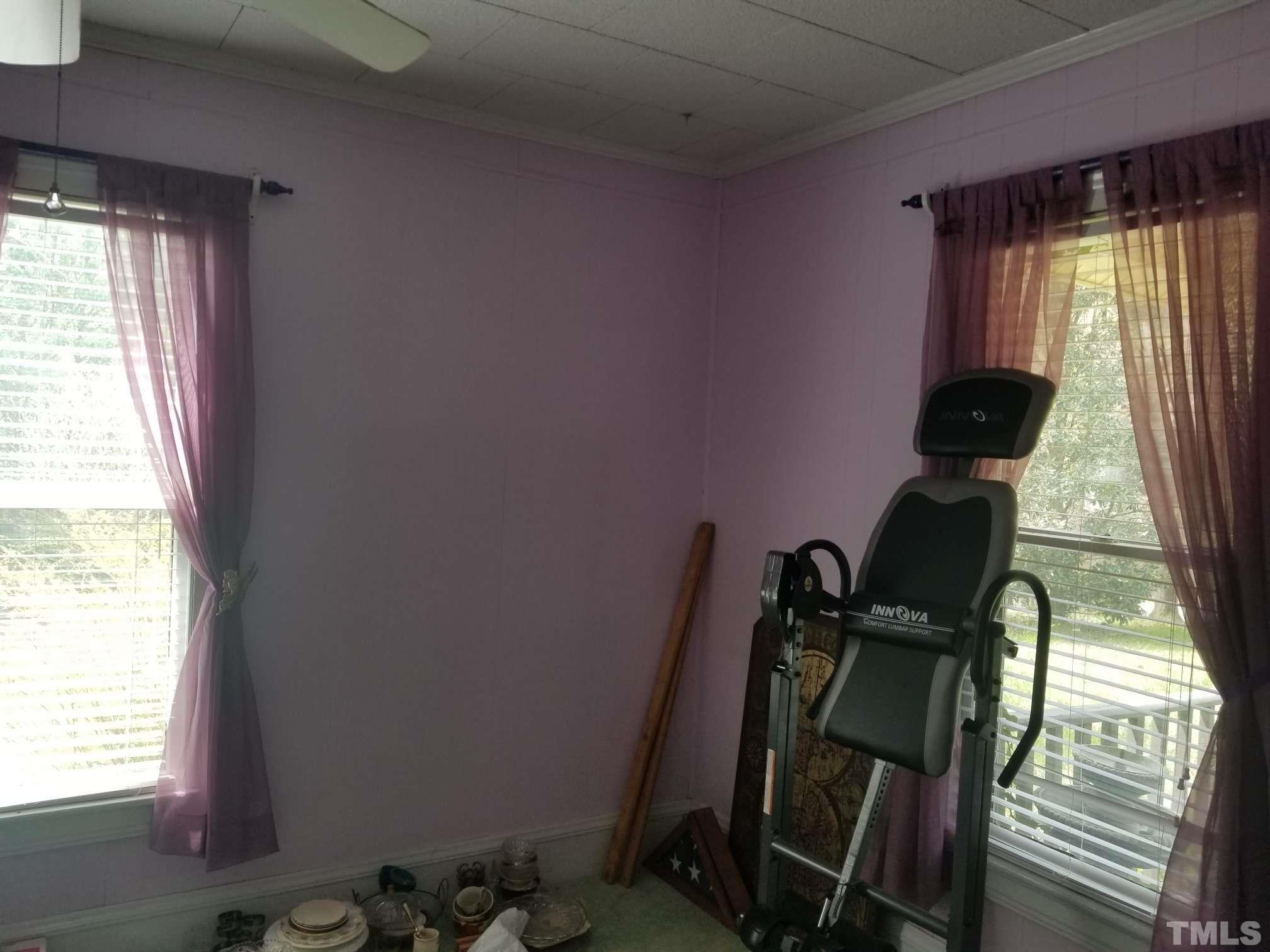 5215 Old Stage Road Raleigh, NC 27603 - Photo 7 of 12 a view of a room with gym equipment and windows