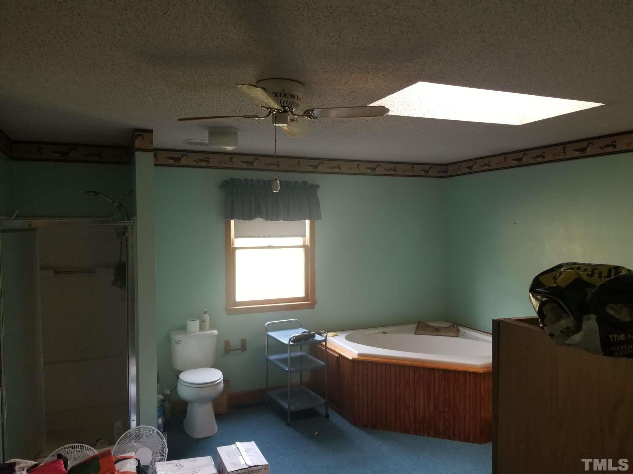 5215 Old Stage Road Raleigh, NC 27603 - Photo 10 of 12 a bathroom with a toilet sink and tub