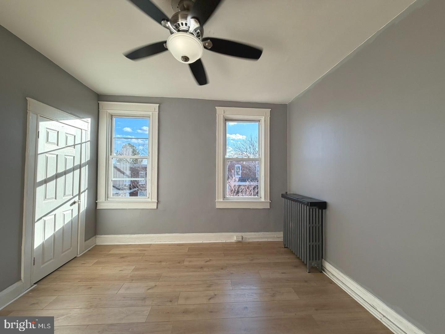 724 East 37th Street Baltimore, MD 21218 - Photo 11 of 21 a view of an empty room with a window and wooden floor