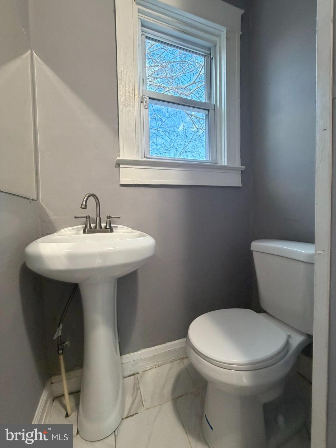 724 East 37th Street Baltimore, MD 21218 - Photo 13 of 21 a white toilet sitting next to a bathroom sink