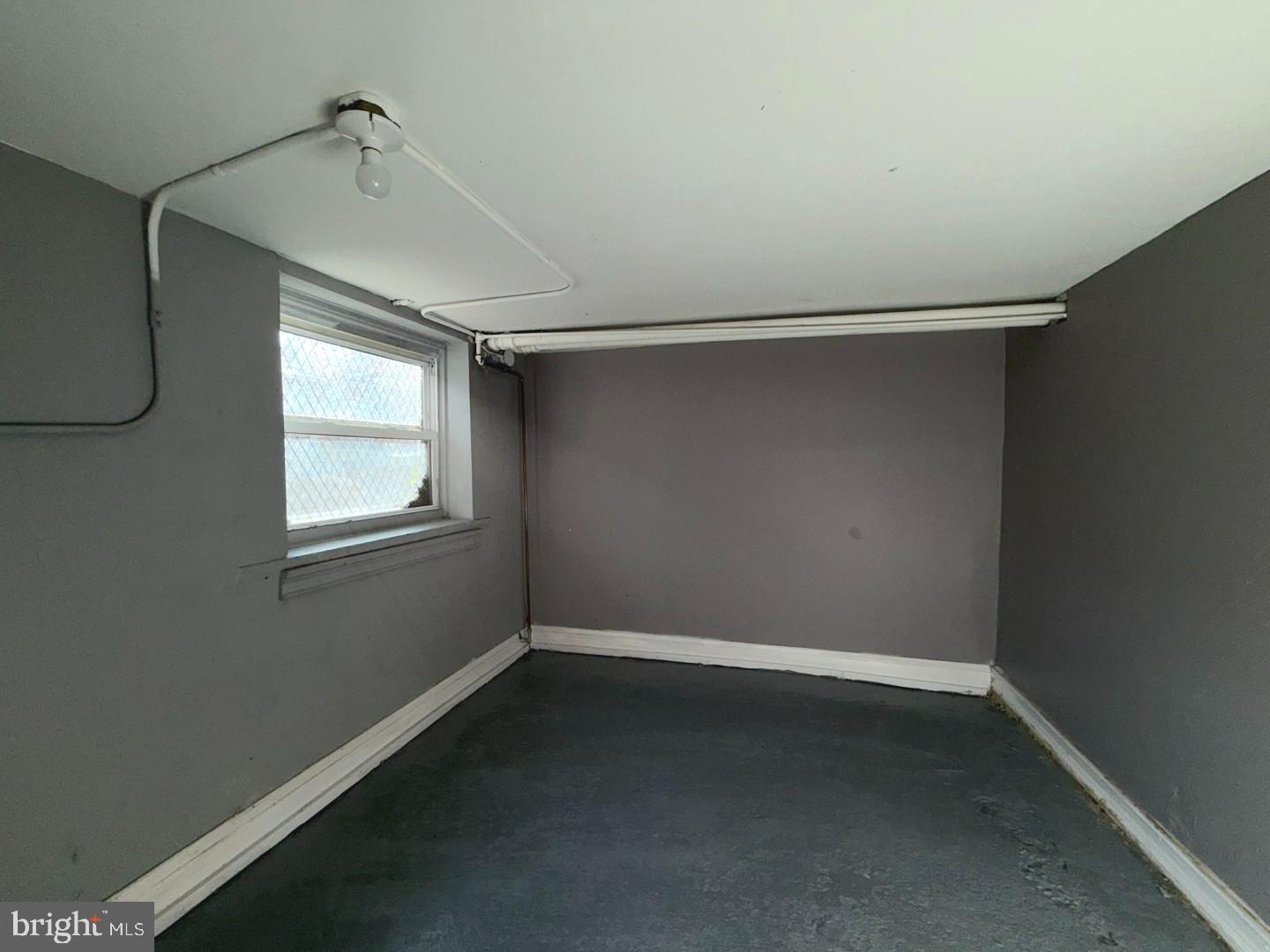 724 East 37th Street Baltimore, MD 21218 - Photo 14 of 21 a view of a room with rack on the wall and a window
