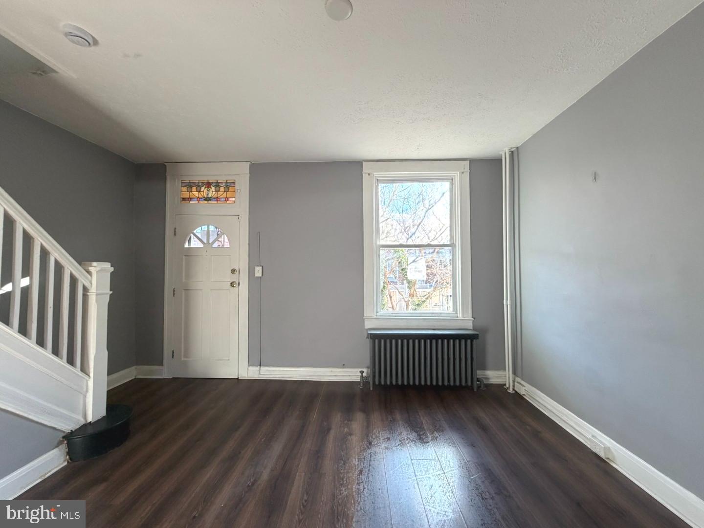 724 East 37th Street Baltimore, MD 21218 - Photo 3 of 21 an empty room with wooden floor and windows