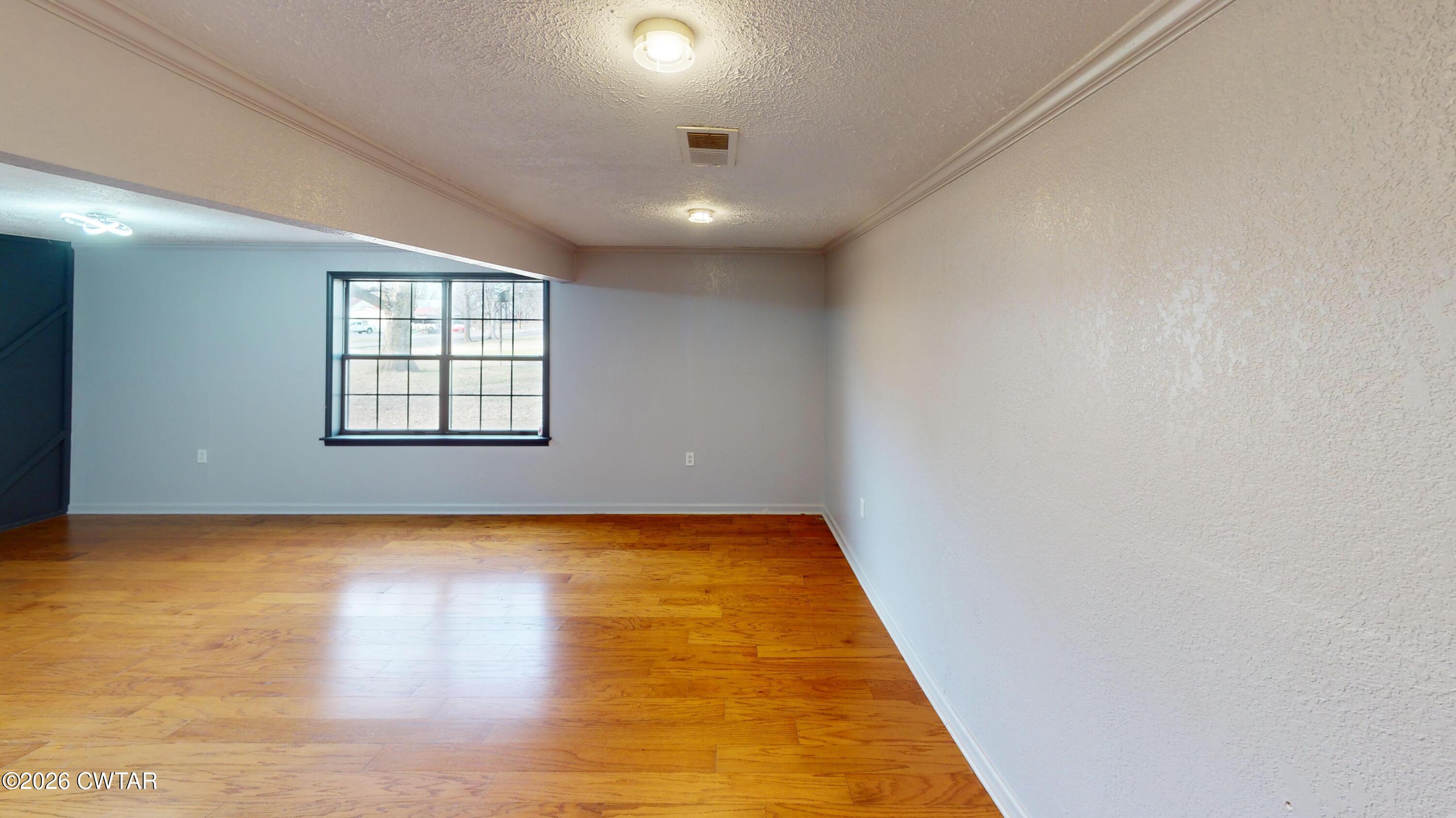 48 Miston Tank Road Ridgely, TN 38080 - Photo 14 of 18 an empty room with wooden floor and windows