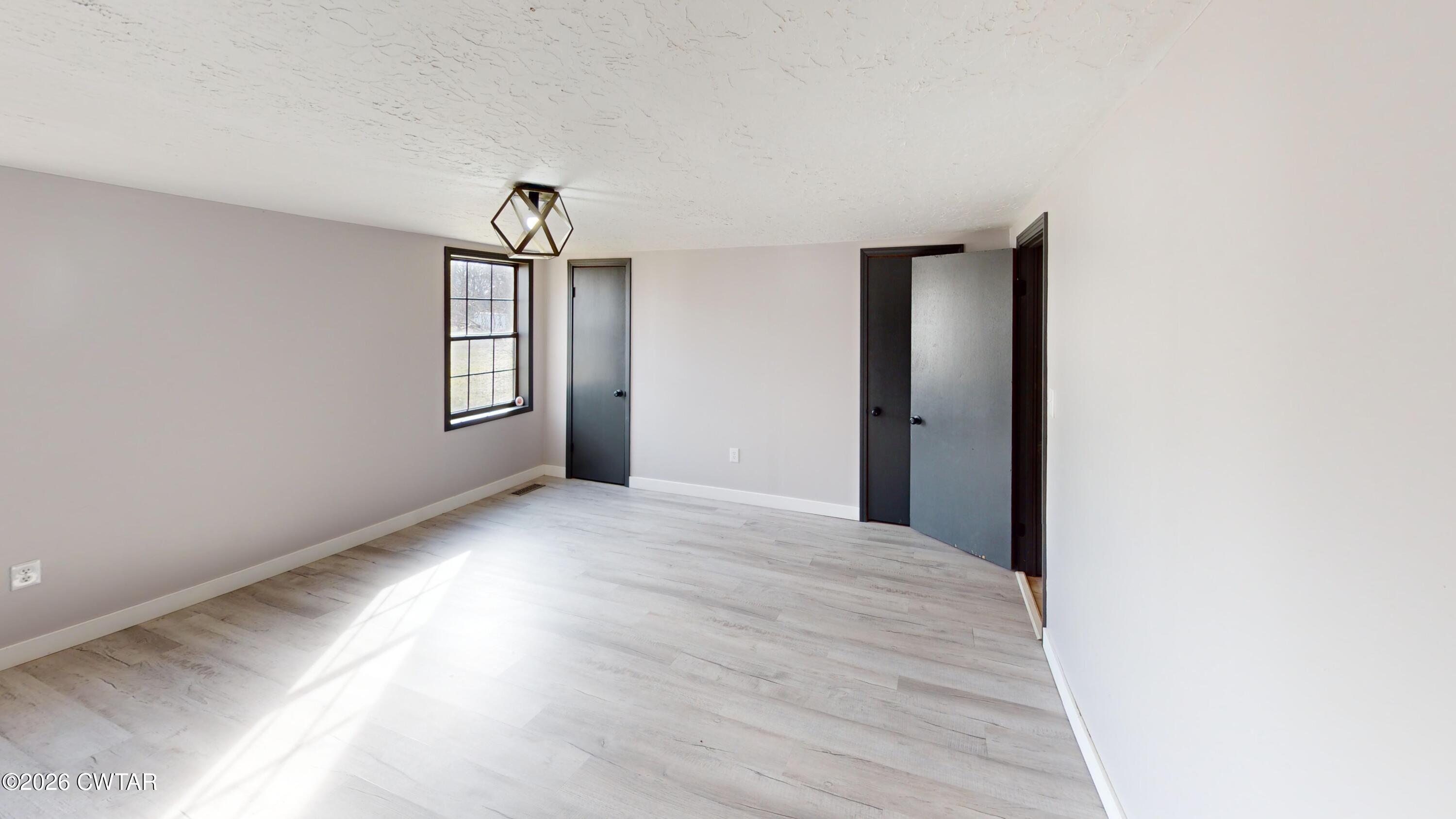 48 Miston Tank Road Ridgely, TN 38080 - Photo 10 of 18 a view of an empty room with wooden floor and a window