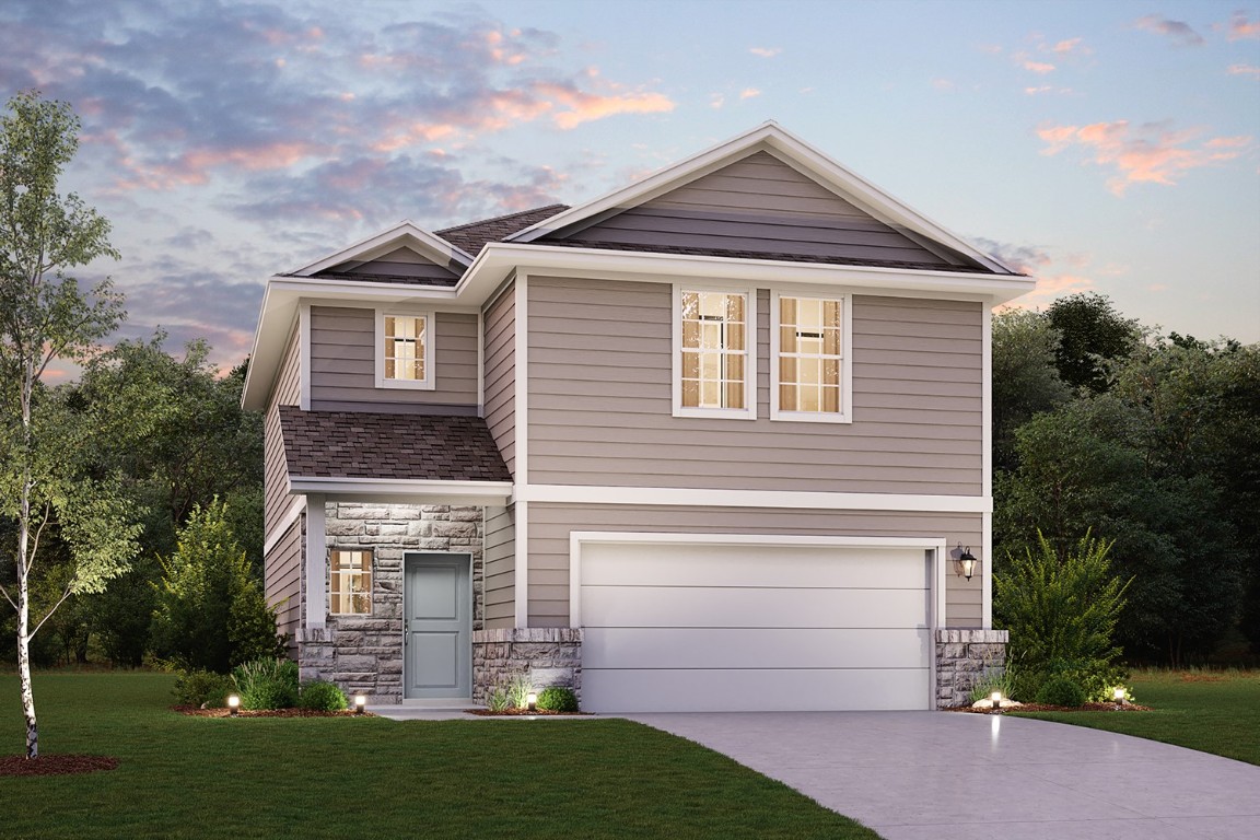 a front view of a house with a garden and plants