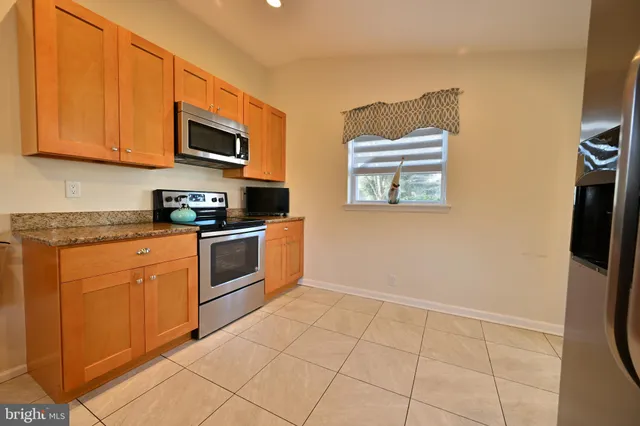 a kitchen with stainless steel appliances a stove a microwave and a refrigerator