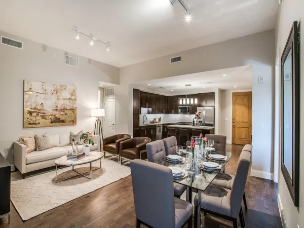 a living room with furniture and a chandelier