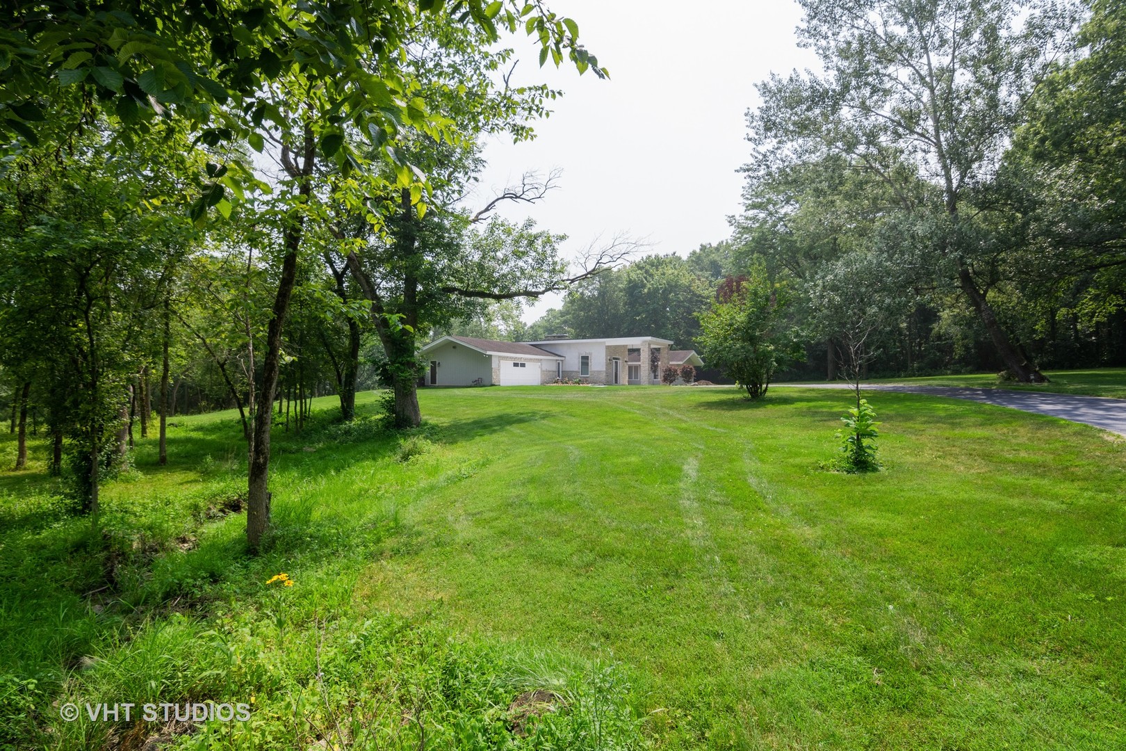34W101 Army Trail Road Wayne, IL 60184 - Photo 2 of 20 a swimming pool with lots of green space and trees in the back