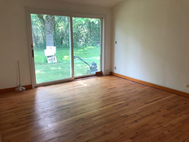 34W101 Army Trail Road Wayne, IL 60184 - Photo 14 of 20 a view of a room with wooden floor and doors