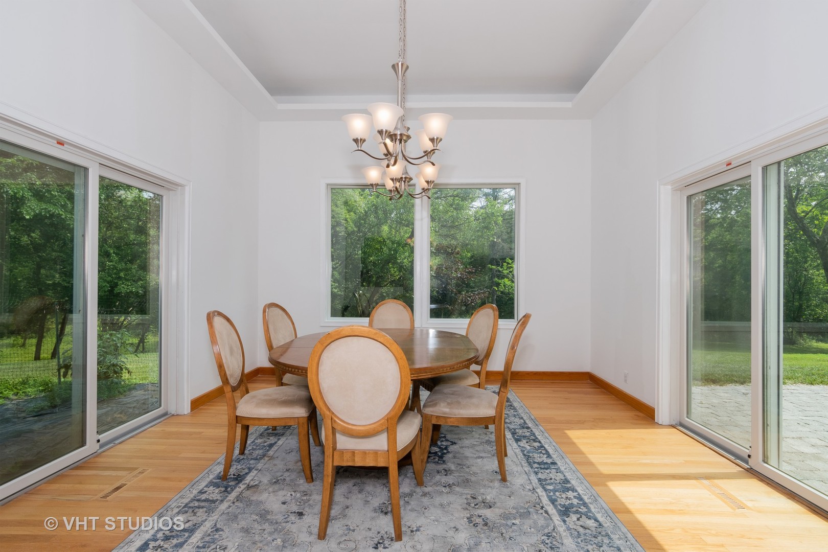 34W101 Army Trail Road Wayne, IL 60184 - Photo 6 of 20 a view of a dining room with furniture wooden floor and a chandelier