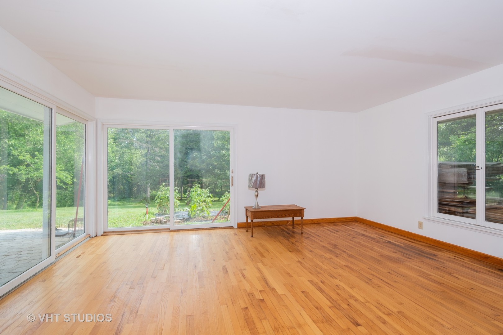 34W101 Army Trail Road Wayne, IL 60184 - Photo 7 of 20 a view of empty room with wooden floor and floor to ceiling window