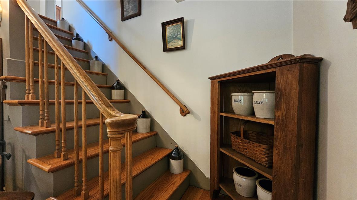 585 Buttermilk Road Hellertown, PA 18055 - Photo 25 of 82 Rich hardwood stairs ascend, framed by a classic wooden railing, offering timeless appeal.