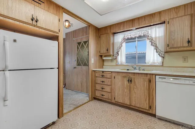 a kitchen with stainless steel appliances a refrigerator stove microwave and sink