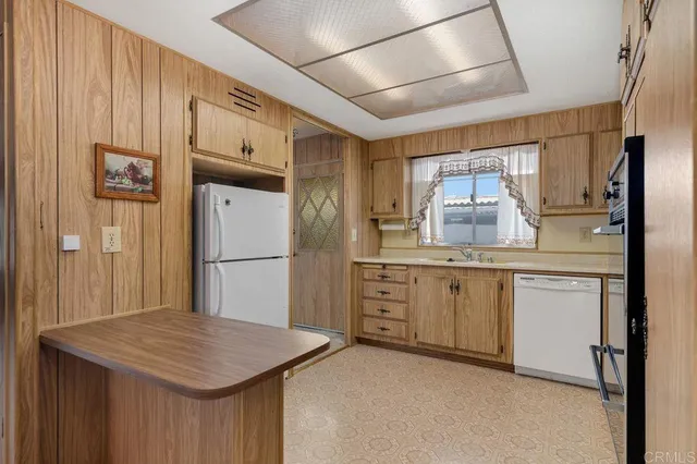a view of a livingroom with furniture window and wooden floor