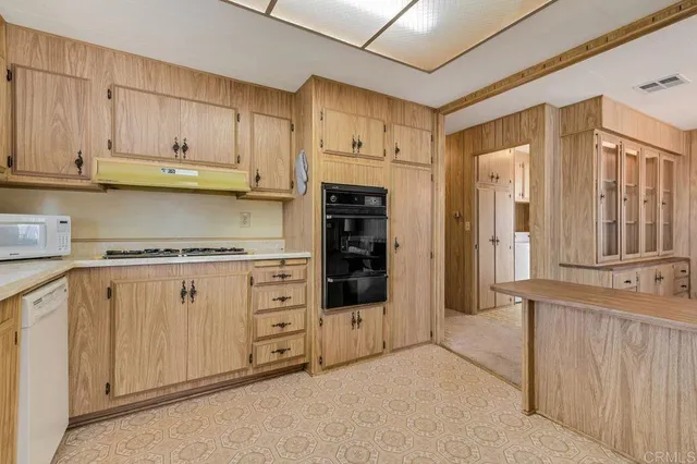 a kitchen with cabinets and stainless steel appliances