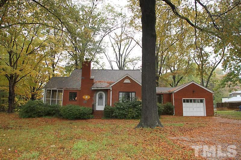 3308 Old Chapel Hill Road Durham, NC 27707 - Photo 1 of 12 a front view of a house with yard and trees
