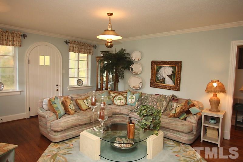 3308 Old Chapel Hill Road Durham, NC 27707 - Photo 2 of 12 a living room with fireplace furniture and a chandelier