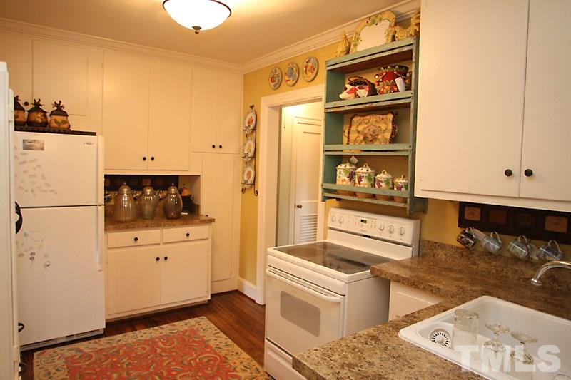 3308 Old Chapel Hill Road Durham, NC 27707 - Photo 5 of 12 a kitchen with stainless steel appliances granite countertop a refrigerator and a stove top oven