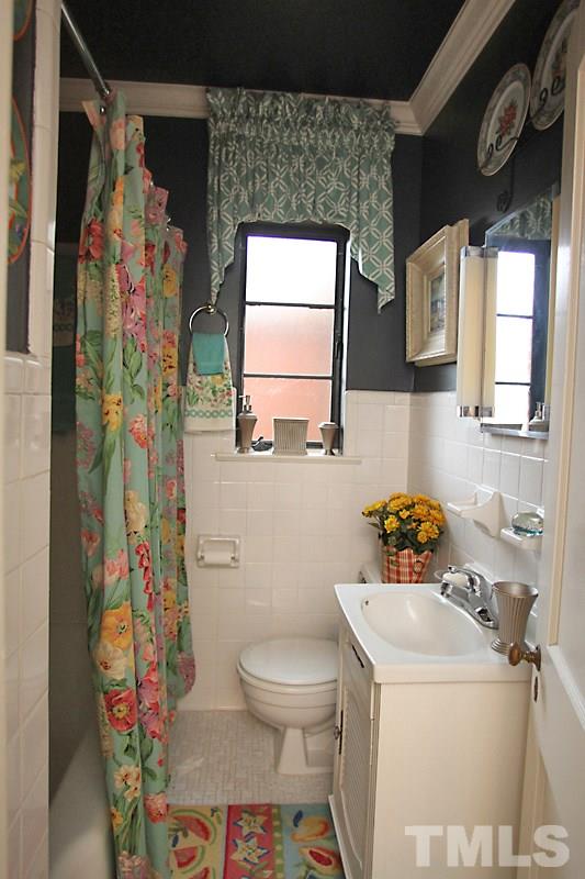 3308 Old Chapel Hill Road Durham, NC 27707 - Photo 7 of 12 a bathroom with a sink mirror vanity and toilet