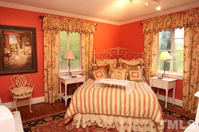3308 Old Chapel Hill Road Durham, NC 27707 - Photo 9 of 12 a bedroom with a bed and wooden floor