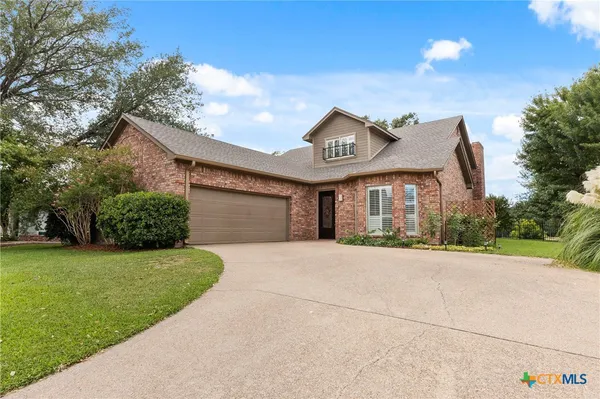 a view of a house with a yard and garage