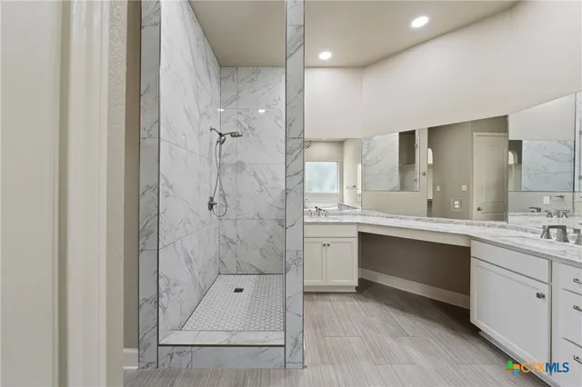 a bathroom with a shower sink and mirror
