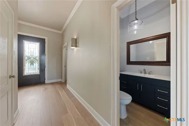 a bathroom with a sink a toilet and a mirror