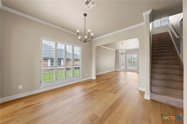 a view of livingroom with furniture wooden floor chandelier