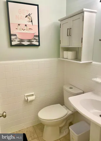 a white toilet sitting next to a bathroom sink