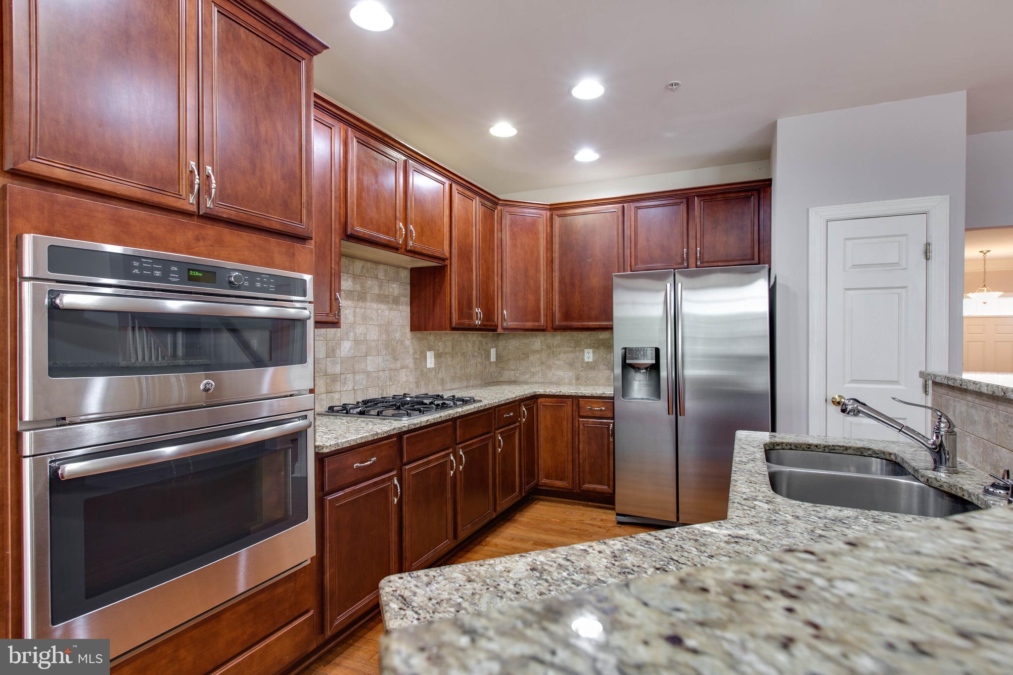 2119 Split Creek Lane Hanover, MD 21076 - Photo 15 of 55 a kitchen with stainless steel appliances kitchen island granite countertop a stove a refrigerator and a sink