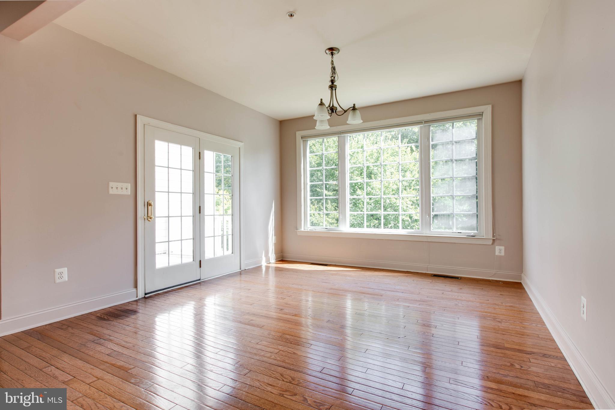 2119 Split Creek Lane Hanover, MD 21076 - Photo 17 of 55 a view of an empty room with wooden floor and a window
