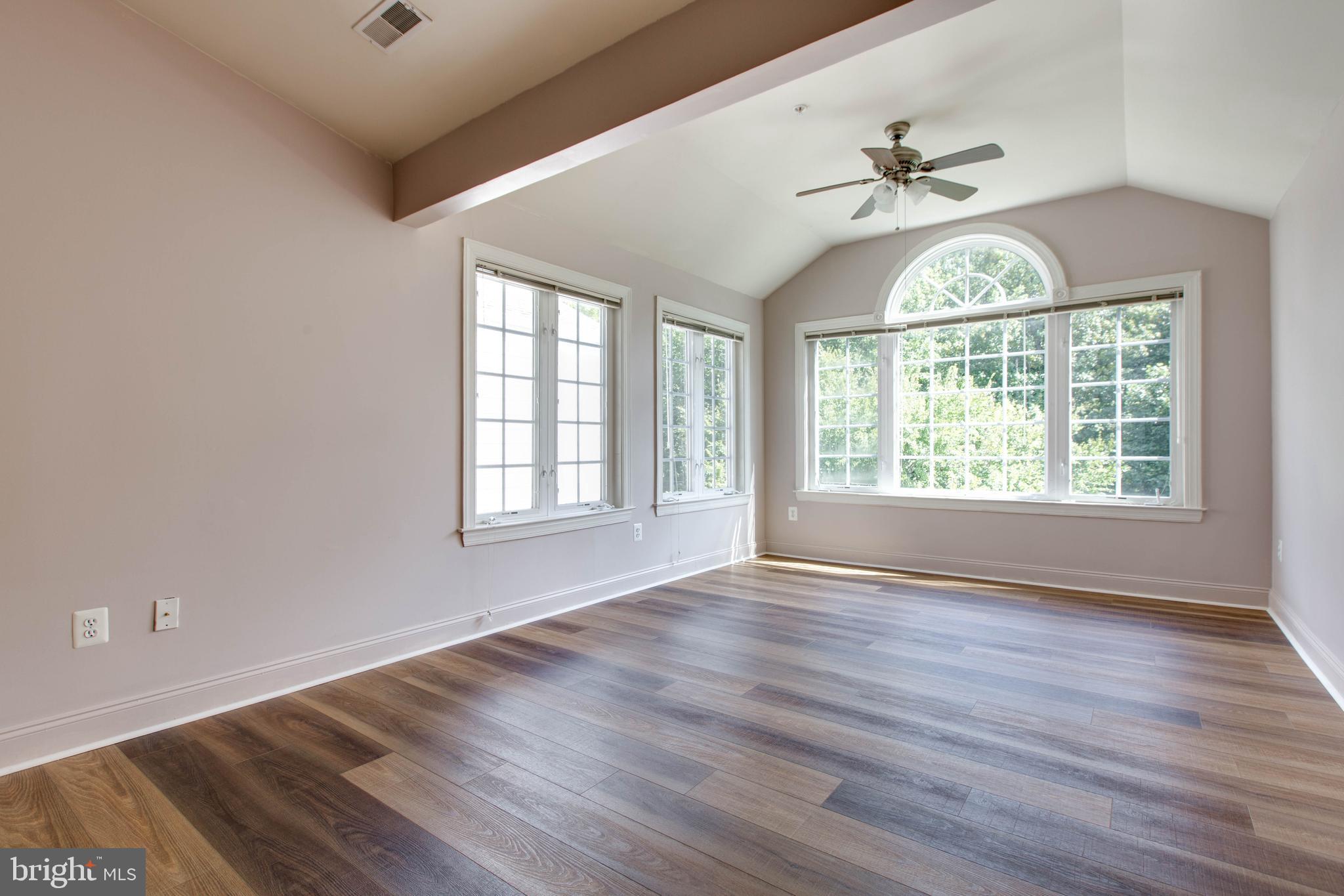 2119 Split Creek Lane Hanover, MD 21076 - Photo 24 of 55 an empty room with wooden floor fan and windows