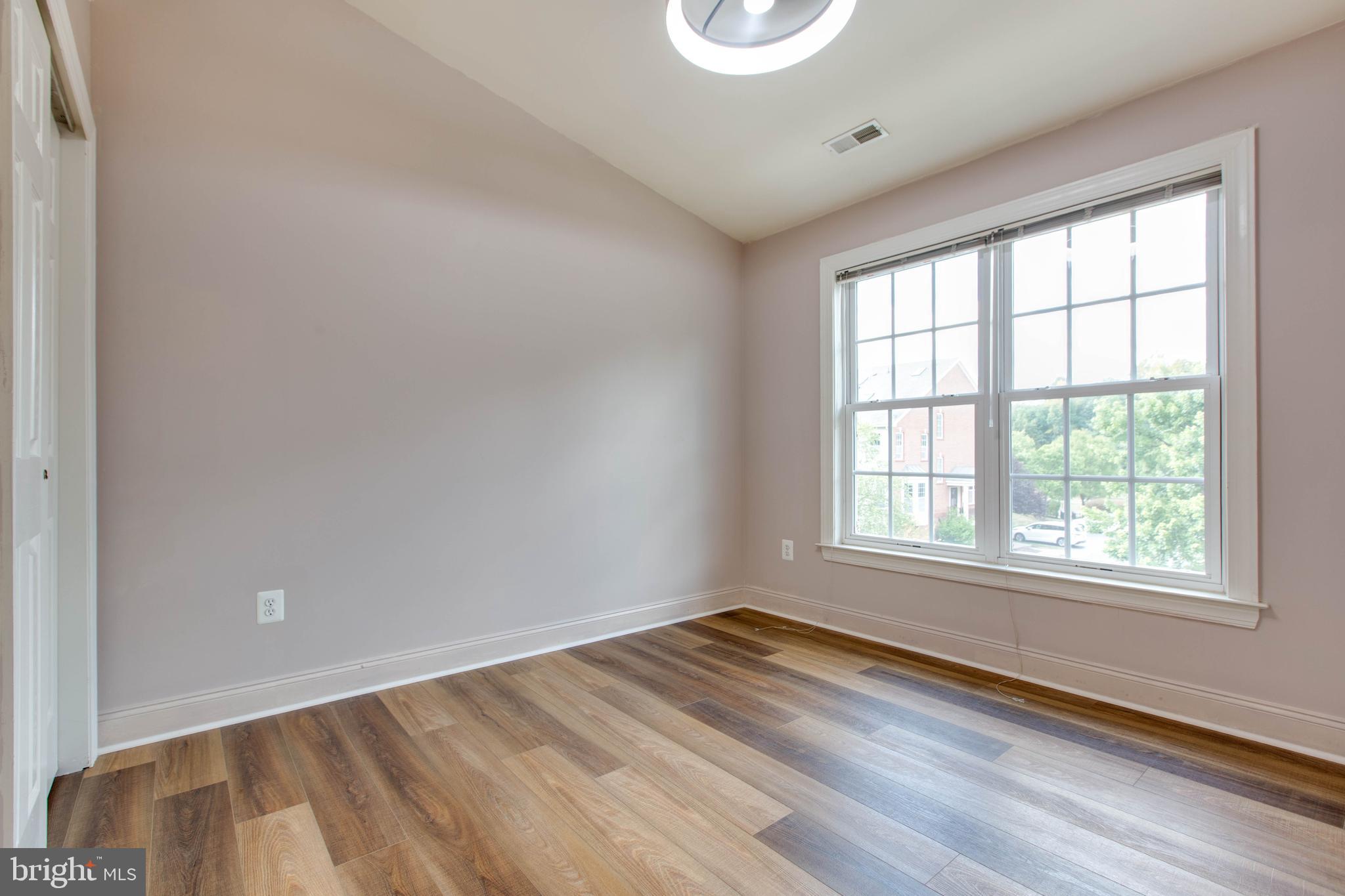 2119 Split Creek Lane Hanover, MD 21076 - Photo 28 of 55 an empty room with wooden floor and windows