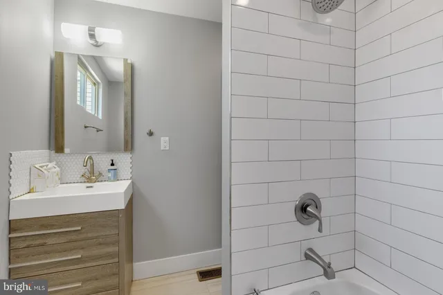 a bathroom with a sink a toilet and mirror