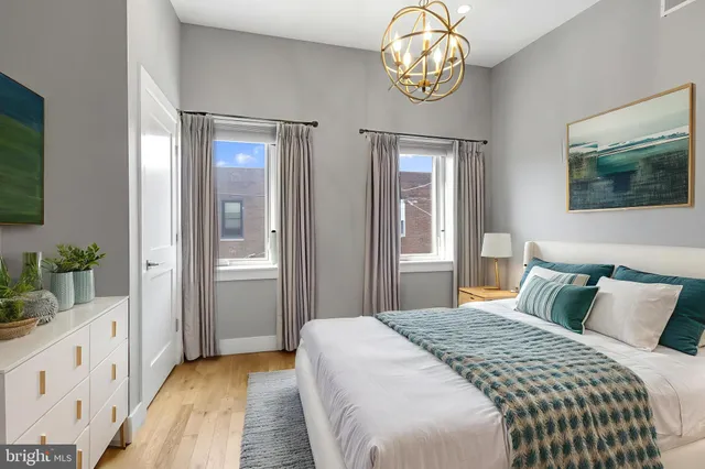 a bedroom with bed and wooden floor