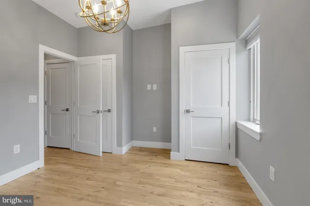 a view of an empty room and wooden floor