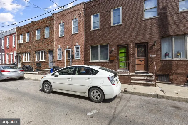 a view of a car parked in front of a building