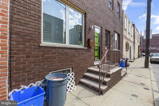 a view of a brick house with outdoor seating