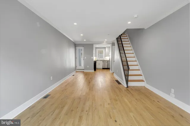 a view of wooden floor and windows in a room