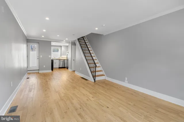 a view of an empty room with stairs and ventilation