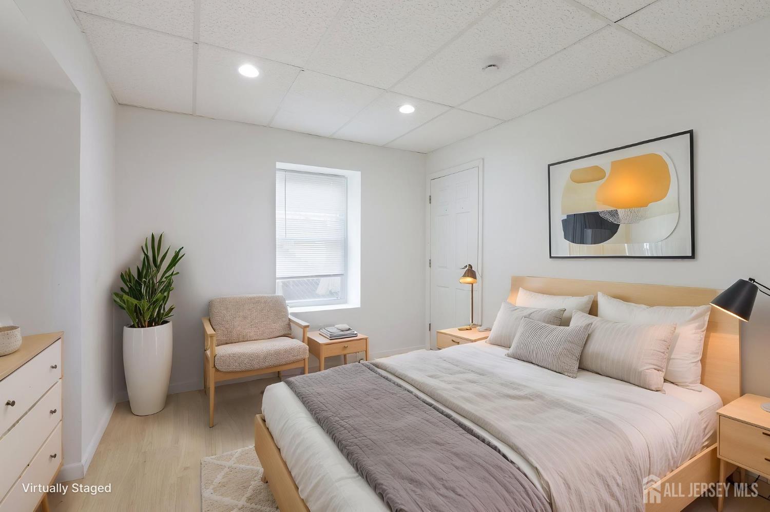 36 Henry Street Edison, NJ 08820 - Photo 27 of 42 a spacious bedroom with a bed and a couch